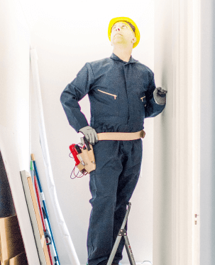 Fixing the wires on a ceiling light fixture.