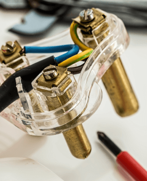 Attaching wires to an electrical outlet.